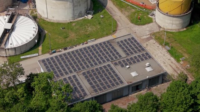 Solar power plant with large tanks in background