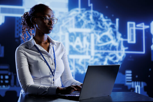 BIPOC woman developing artificial intelligence neural networks nodes modeled after human brain. Tech support setting up AI machine learning accurately making predictions using data