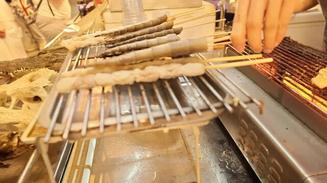 Thailand street food crocodile skewers grilling barbecue exotic meat market scene