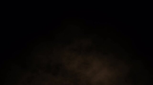 Sand dust particles blowing in wind on black background. dramatic soil powder smoke overlay seamless loop 4k. brown sand dust storm particles moving fast on black background.