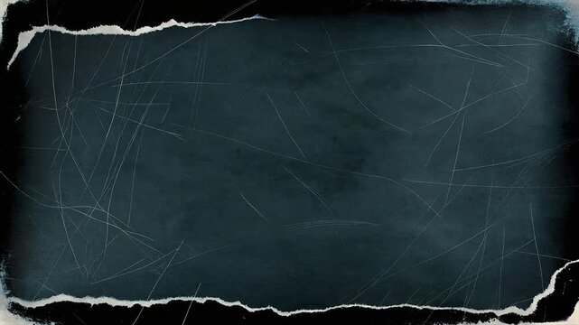 Roughly torn edges frame a dark, chalk-dusted surface. Faint scratches mark the worn, grungy texture. The surface suggests aged, forgotten notes or scribbles