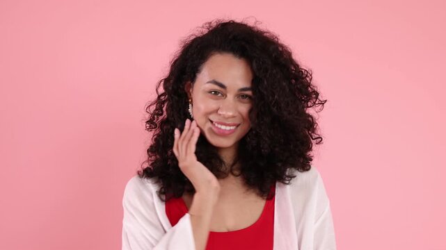 Beautiful woman wearing red swimsuit and beach kimono on pink background