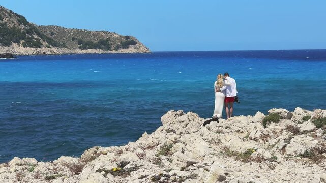 Romantic Couple Standing on Rocks Overlooking Cala Agulla Beach Mallorca
