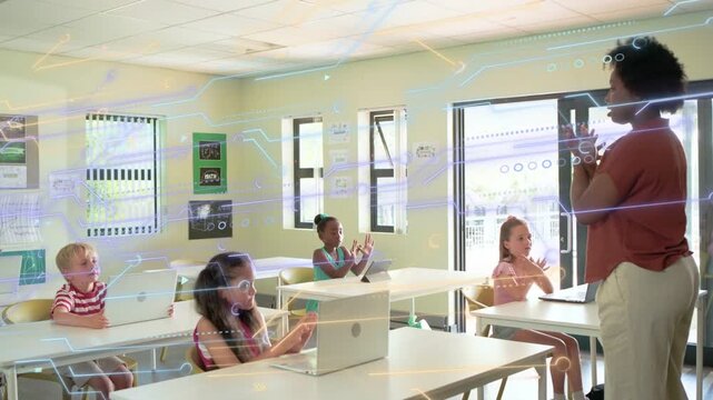 Teacher entering, showing gestures, students copying while laptops showing AR overlay for education