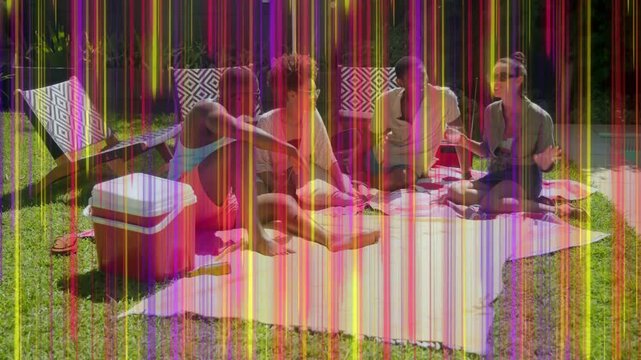 Four adults making lifestyle clip on picnic, frames advancing sparking color streaks covering scene