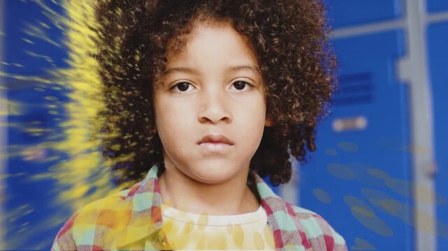 Education student boy standing in front of blue lockers, yellow splash appearing and creating smile