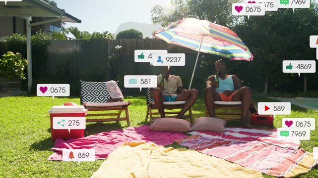 Two men lounging under umbrella, social notifications multiplying after post around men on towels