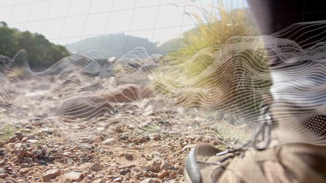 Outdoor hiker stepping rocky trail causing heel-toe motion with wavy overlay tracking toward hills