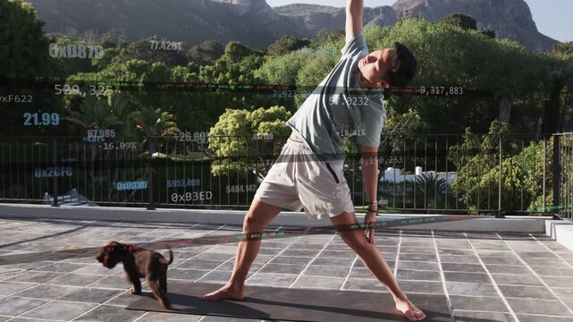 Man doing rooftop yoga on mat, dog entering causing shifting, keeping balance with fitness tracking
