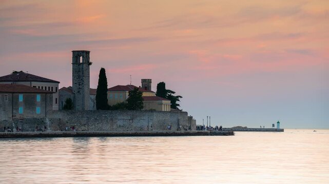 Sunset time lapse over the historic coastal architecture of Porec, Croatia, featuring the Euphrasian Basilica bell tower and shifting sky colors