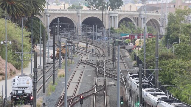 Light Rail Train Travels Under A Bridge