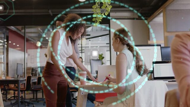 Standing woman pointing at docs, activating rings pulsing over desk while peer reviewing in office