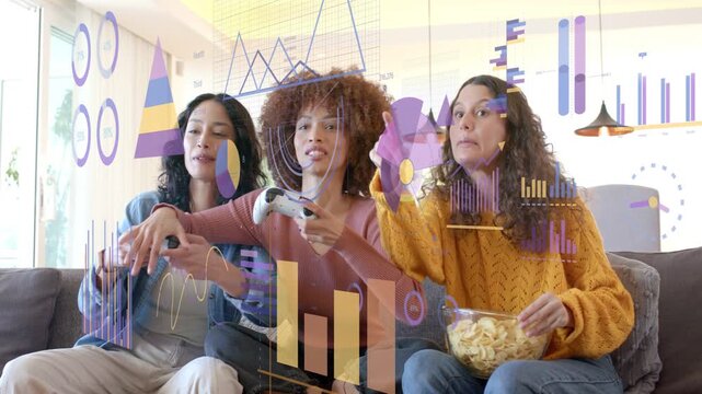 Three women sitting on couch holding white pads eating chips, gaming inputs causing HUD highlights
