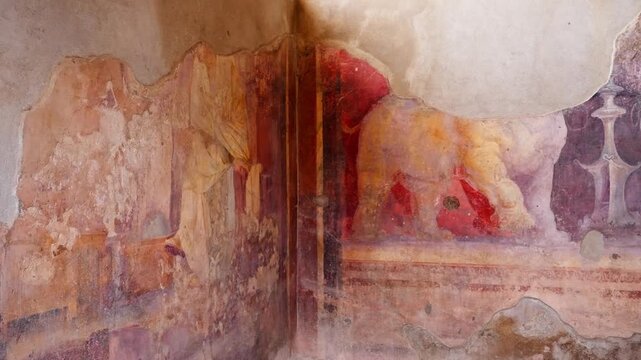 Close-up of a faded Pompeii fresco wall showing animal figures, red painted panels, and decorative ancient Roman interior artwork with weathered plaster texture.