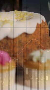 Camera zooming right revealing bundt, cupcakes in bakery, finance charts over goods animating sales