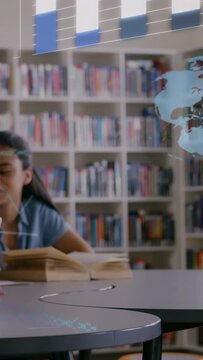 Vertical video: Student turning page in library sparking data overlay with bars code aiding study