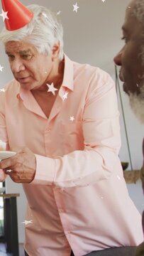 Vertical video: Host leaning forward offering lit cupcakes, star overlays around plate for birthday