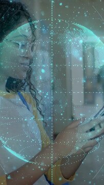 Vertical video: Teen tapping phone as AR globe appearing rotating over face smiling at msg for tech