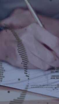 Vertical video: Pen hovering, woman signing business forms while halftone overlay tracing strokes