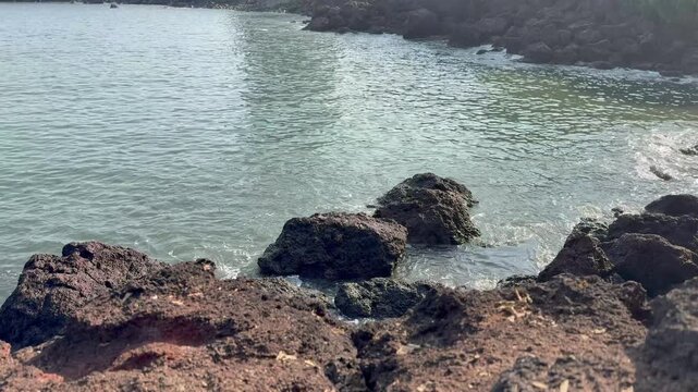 Beautiful 4K view of sea waves crashing against rugged rocks near Karhateshwar Mandir. Coastal breeze, endless blue waters, and serene Konkan beauty create a mesmerizing scene.