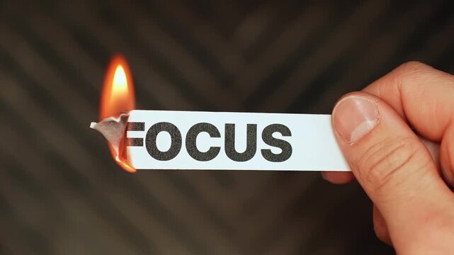Burning &ldquo;focus&rdquo; label symbolizes distraction, procrastination, scattered thinking, and loss of concentration in a bold conceptual close-up.
