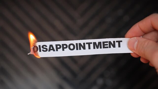 Burning &ldquo;DISAPPOINTMENT&rdquo; concept symbolizing healing, acceptance, emotional release, and moving beyond unmet expectations, setbacks, and personal letdowns.