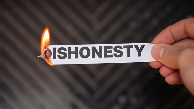 Burning &ldquo;DISHONESTY&rdquo; concept symbolizing truth, integrity, transparency, and release from lies, deceit, fraud, and broken ethical behavior.