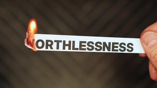 Burning &ldquo;WORTHLESSNESS&rdquo; concept symbolizing self-worth, confidence recovery, emotional healing, and releasing feelings of inadequacy, shame, and low self-esteem.