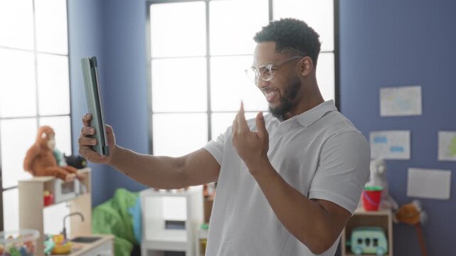 Man holding tablet with outstretched hand and gesturing with free hand in classroom; joyful connection.