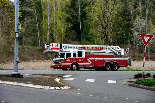 BELLEVUE, WA &ndash; APR 7, 2026: Redmond Fire department ladder fire truck parked on the side of the road next to wetland, spring day
