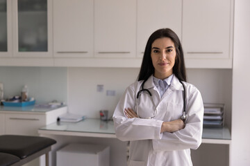 Insurance, mission and professionalisms in medical sphere. Portrait of self-assured Hispanic woman...