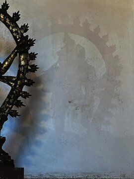 Lord Shiva Nataraja Statue Casting Dramatic Shadow on Textured Wall