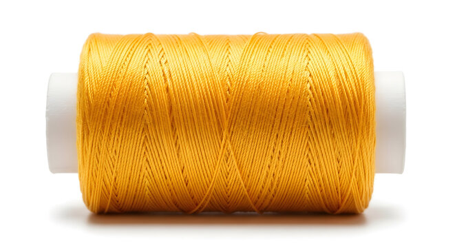 Spool of yellow thread sewing material for crafts and tailoring isolated on white background