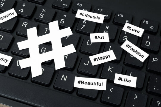 Popular hashtags printed with sign on paper and on the keyboard.