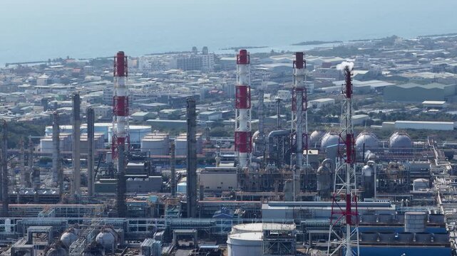 Aerial close up drone video of plastic manufacturing and chemical industry in Mueang Rayong District, Thailand, showing industrial production, petrochemical infrastructure, and factory operations.