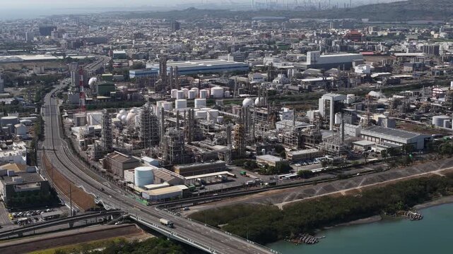 Aerial close up drone video of plastic manufacturing and chemical industry in Mueang Rayong District, Thailand, showing industrial production, petrochemical infrastructure, and factory operations.