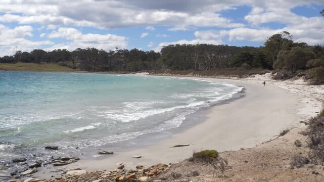 Person Walking Along The Coastline Of Maria Island In Tasmania, Australia. Wide Shot
