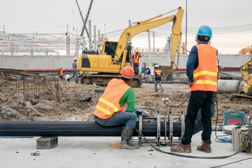 Fototapeta premium Construction worker connect HDPE pipe in construction site