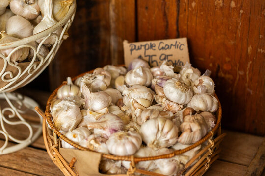 Fresh garlic for sale in rustic wooden crates at shop