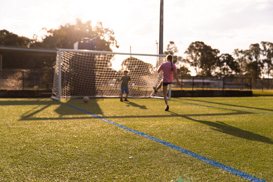 kids playing soccer with a goalie and striker