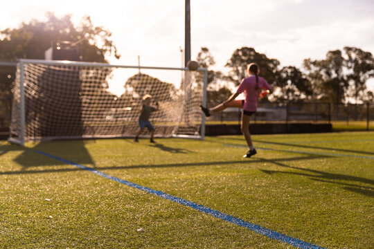 kids playing soccer and shooting at the goal