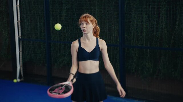 Woman padel player practicing ball bouncing on racket