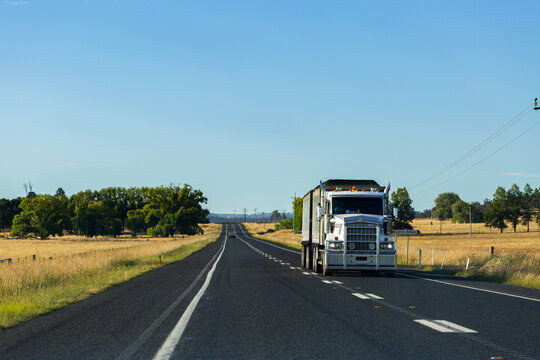 Semi trailer truck transporting goods through Australia on highway