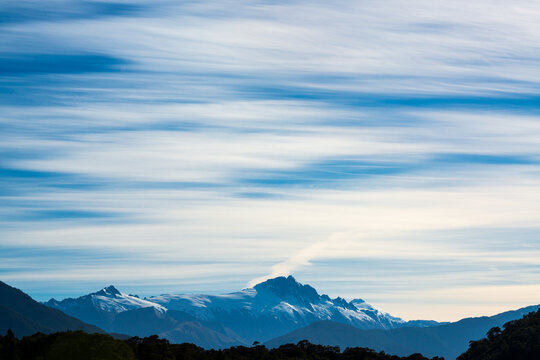 View of Mt Cook with streaky cloud patterns over deep blue sky