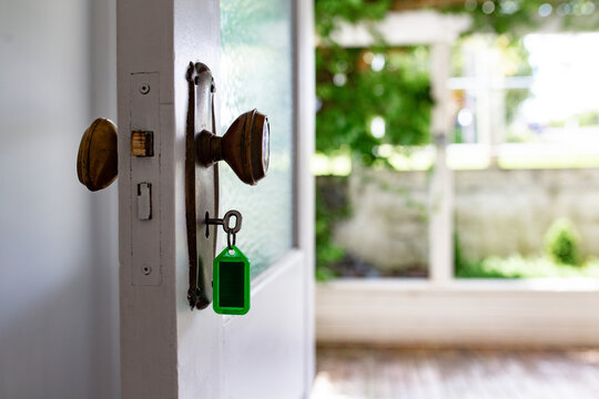 Housekey inserted into the door lock of an open door