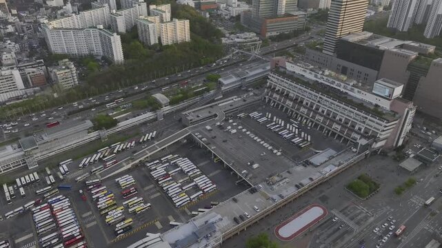 Aerial view of Seoul Express Bus Terminal at sunset with heavy traffic and city lights, Gangnam, South Korea.