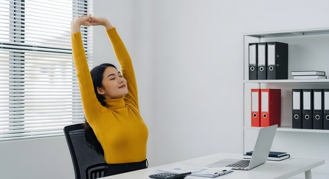 Woman stretching at office desk