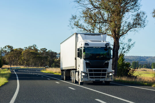 truck transporting goods through rural Australia on highway
