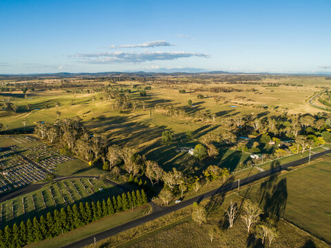Aerial view over rural farm landscape with green paddocks in NSW tableland