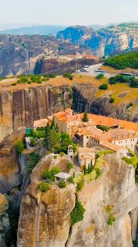 Vertical video. Meteora, Kalabaka, Greece. Monastery of St. Stephan. Meteora - rocks, up to 600 meters high. There are 6 active Greek Orthodox monasteries listed on the UNESCO list. Drone footage, Po